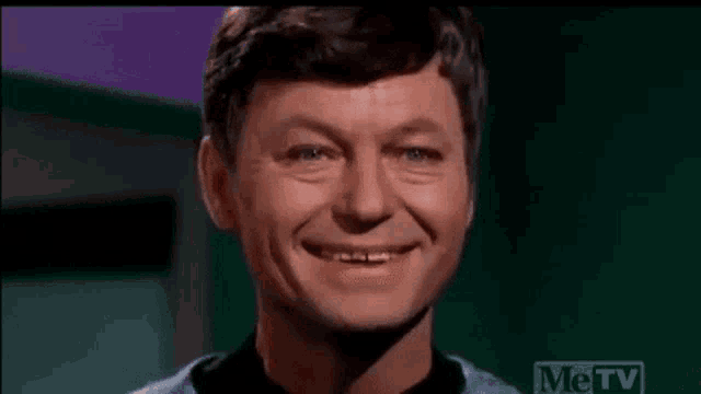 a close up of a man 's face with a smile on it .
