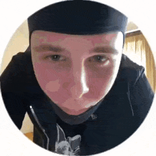 a close up of a man 's face in a circle wearing a hat .