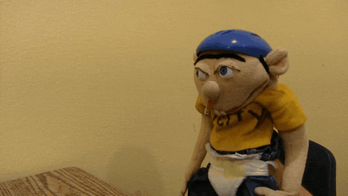 a stuffed animal wearing a yellow shirt that says off city on it