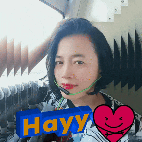 a woman wearing a headset has the word hayy written on a blue block