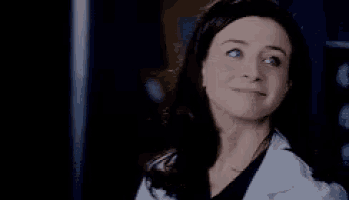 a close up of a woman wearing a white lab coat