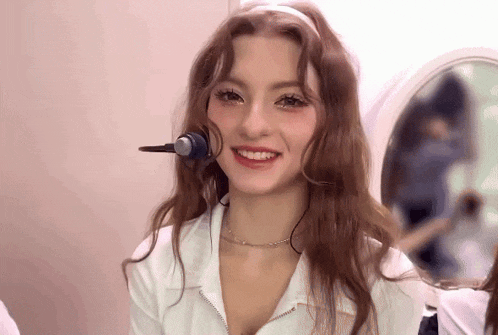 a woman wearing a headset is smiling and looking at the camera
