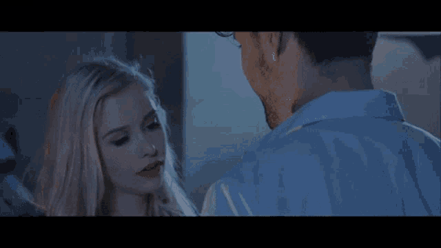a man and a woman are looking into each other 's eyes