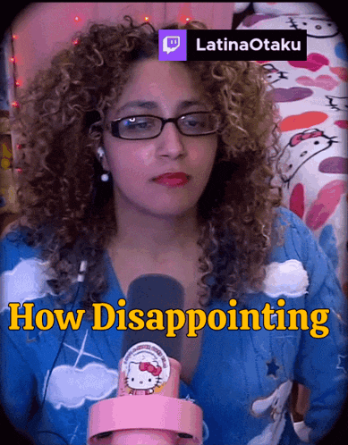 a woman with curly hair is wearing glasses and holding a hello kitty microphone