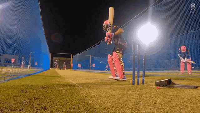 a cricket player is swinging a bat at a wicket while wearing a jersey that says ' sydney '