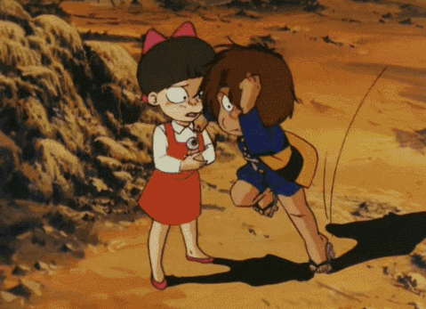 a girl in a red dress is standing next to a man in a blue shirt