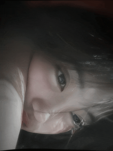 a close up of a woman 's face with her eyes visible