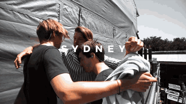 a group of young men hugging with the word sydney on the bottom