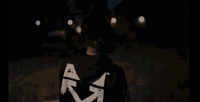 a person standing on a sidewalk with their hands over their face