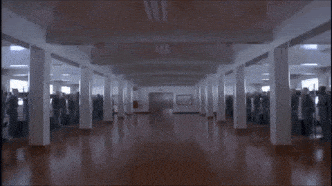 a man walking in a hallway with the word cocksucker written on the bottom