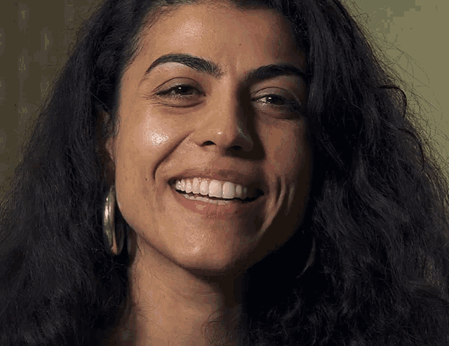 a close up of a woman 's face with a big smile