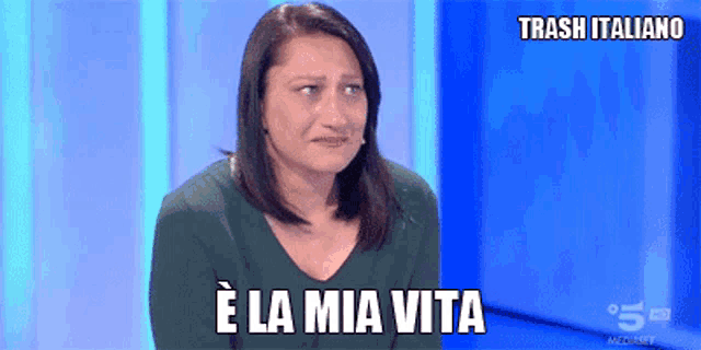 a woman is crying on a tv show and the words trash italiano are above her