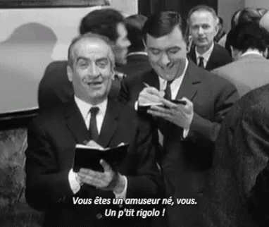 two men in suits and ties are standing next to each other in a crowd .