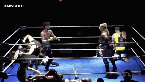 a wrestling ring with the hashtag #aiwgold on the bottom