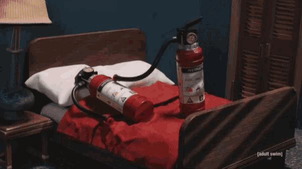 a bed with a fire extinguisher on it and the words fire extinguisher porn below it