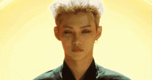a close up of a man 's face with a yellow background