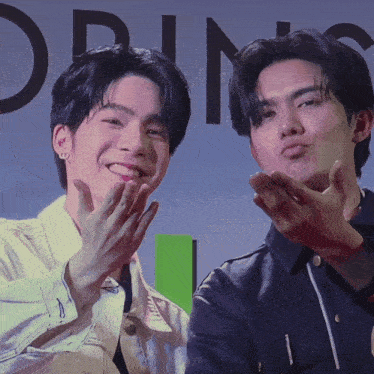 two men are making funny faces in front of a sign that says ' orin ' on it