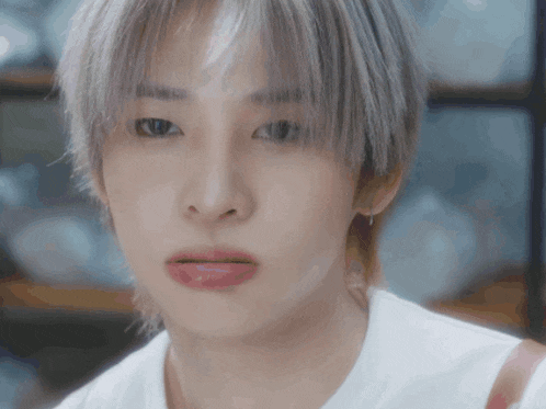 a close up of a person 's face with white hair and pink lips