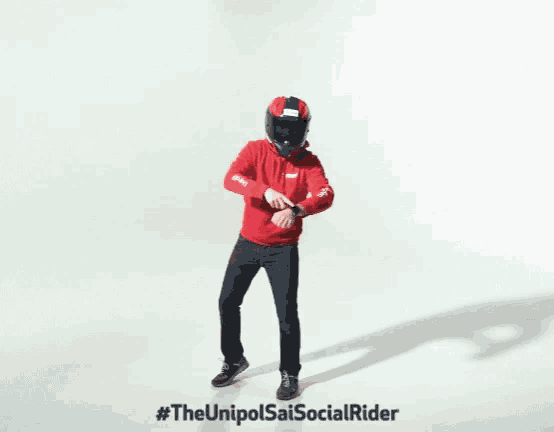 a man wearing a helmet and a red hoodie is dancing in front of a white background
