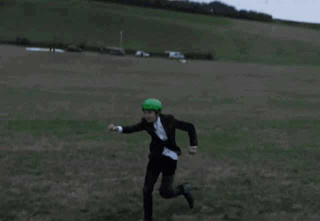a man in a suit is being pulled by a paraglider and says yeah