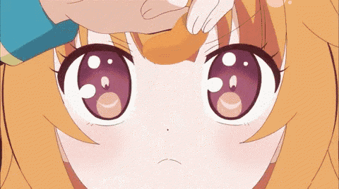 a close up of a girl 's face with a hand on it