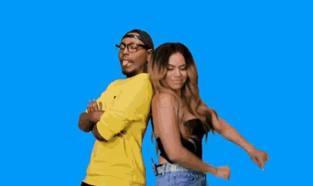 a man and woman are standing back to back with their arms crossed .