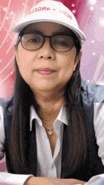 a woman wearing glasses and a white hat that says ' j3dma ' on it