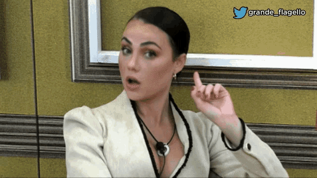 a woman with a surprised look on her face has a twitter account named grande_flagello