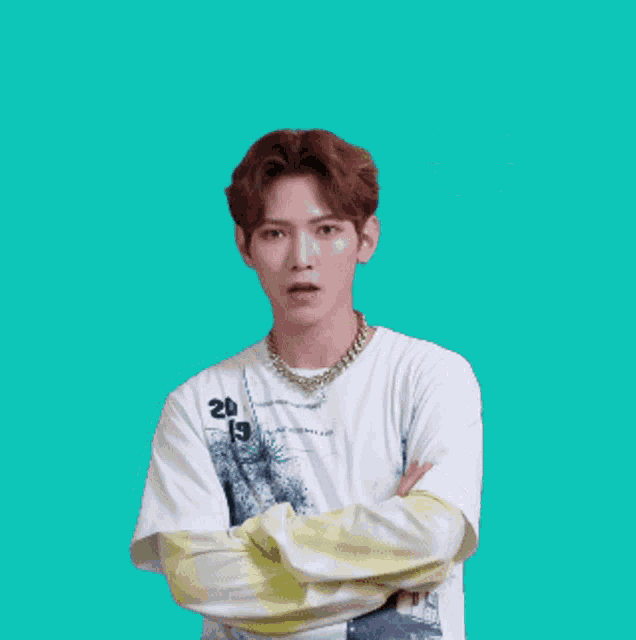 a man with his arms crossed is wearing a shirt that says ' 20 ' on it
