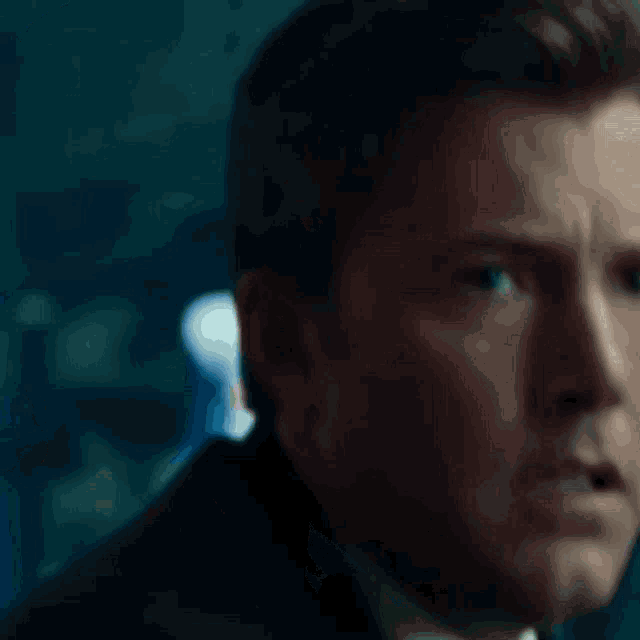 a close up of a man 's face with a serious look on his face