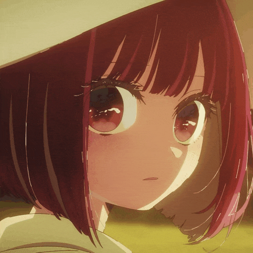 a close up of a girl 's face with red hair