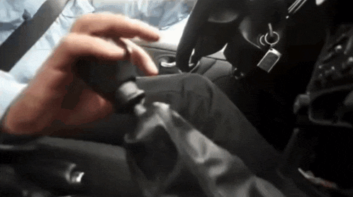 a close up of a person 's hand on a car shifter