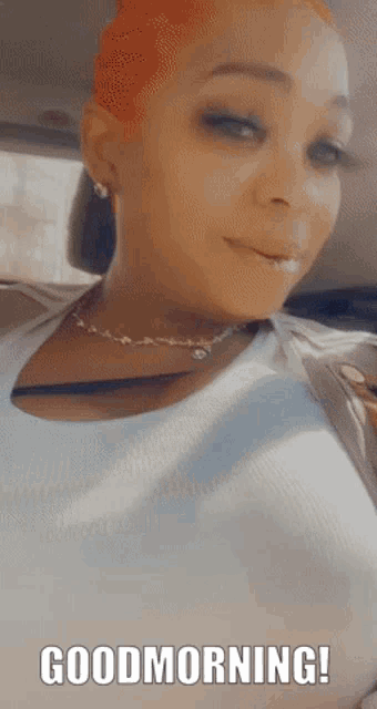 a woman in a car says " good morning " on the screen