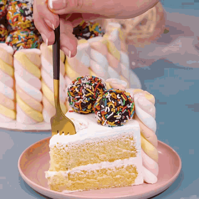 a person is cutting a slice of cake with marshmallows and sprinkles on top