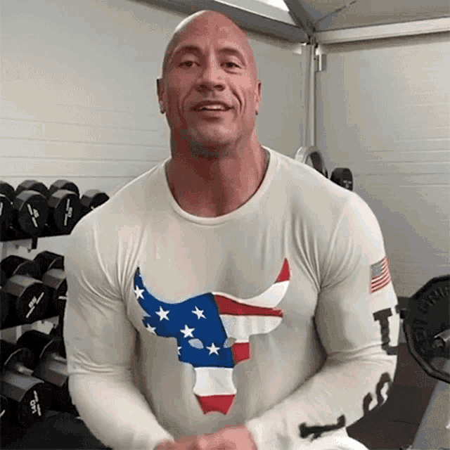 a man wearing a white shirt with a bull on it