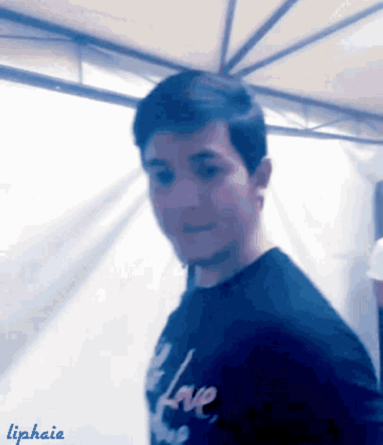 a blurry picture of a man wearing a shirt that says love on it