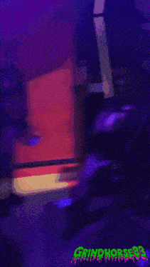 a man playing a guitar in front of a sign that says grinchfest