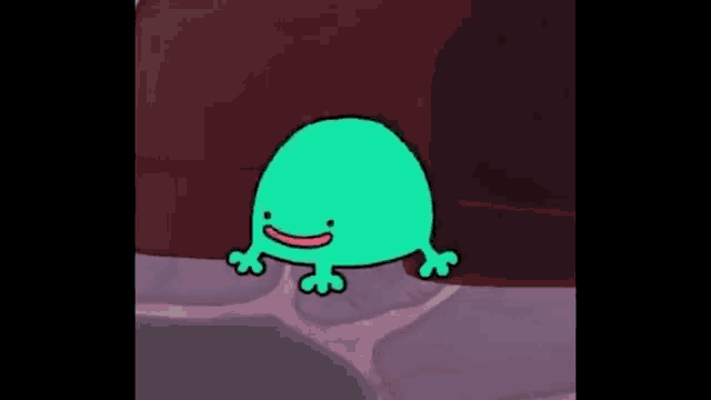 a green frog is standing on a rocky surface with a smile on its face .