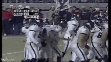 a group of football players are standing on the field during a game .