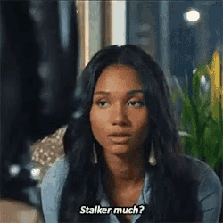 a woman in a blue shirt is talking to another woman and says stalker much .