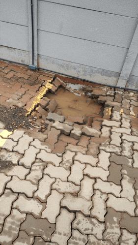 a brick walkway with a hole in the middle