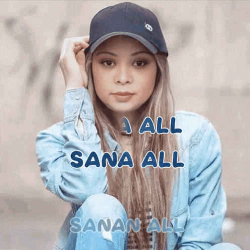 a woman wearing a baseball cap and a denim jacket with sana all written on the bottom