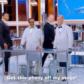 a group of men in lab coats are standing around a table with the words get this phony off my stage