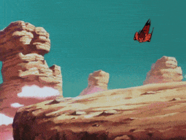 a butterfly is flying over a rocky landscape