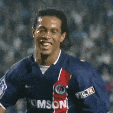 a man wearing a thomson jersey is smiling