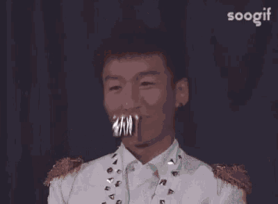 a man with chinese writing on his face and the word soogif in the corner