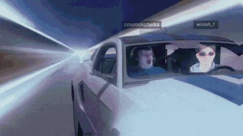 two people are driving a car with cosmokoteika and woosh_f written on the side