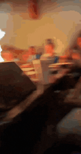 a blurry picture of a group of people sitting around a table
