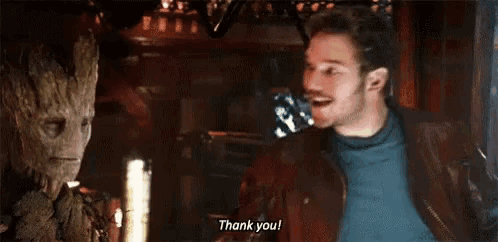 a man and a groot are standing next to each other and the groot is saying thank you .