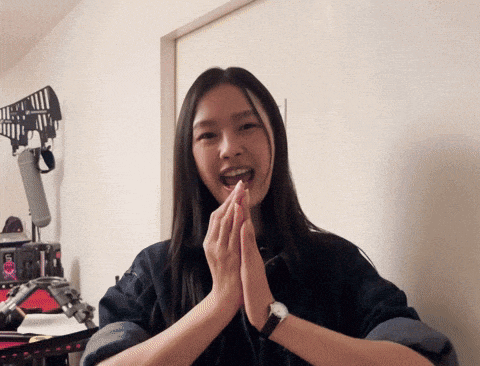 a woman wearing a watch is smiling with her hands together